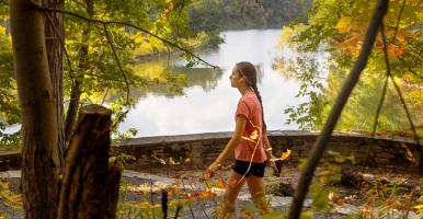 Student walking in front of Beebe Lake
